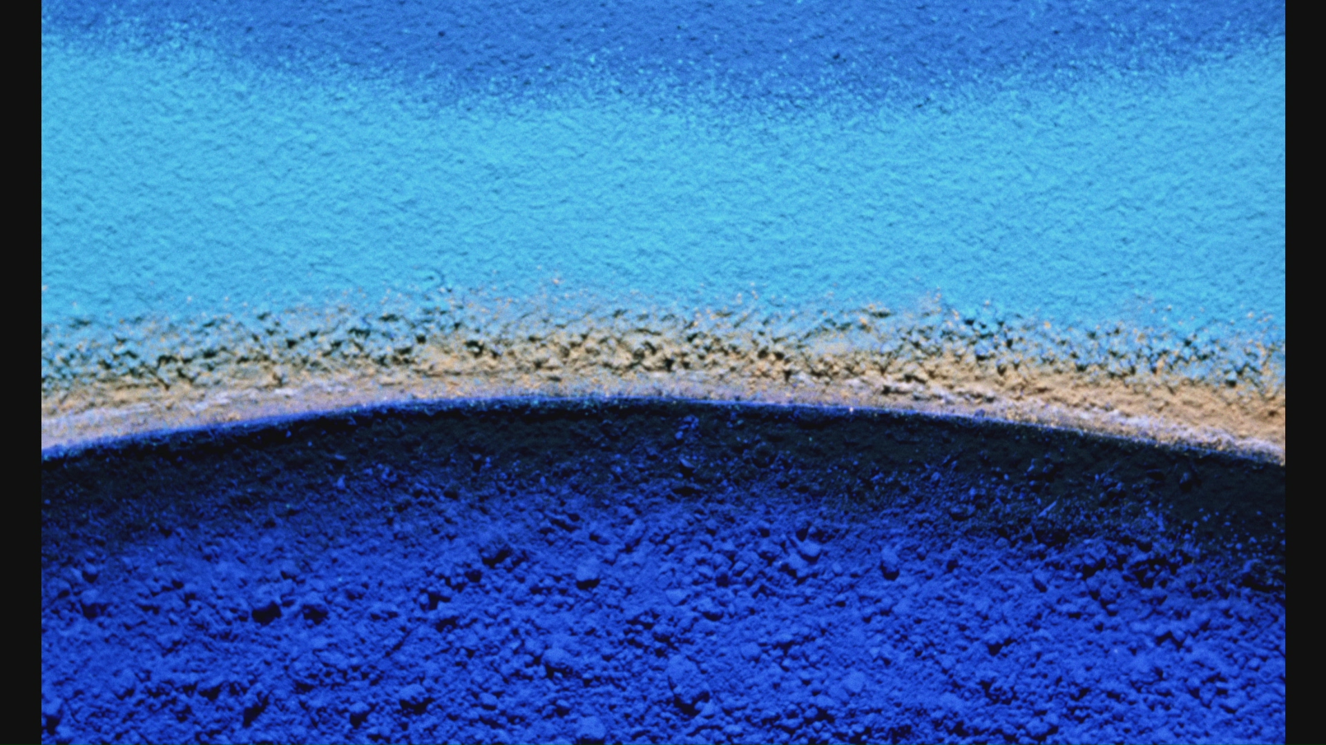blue powdery pigments making an arch