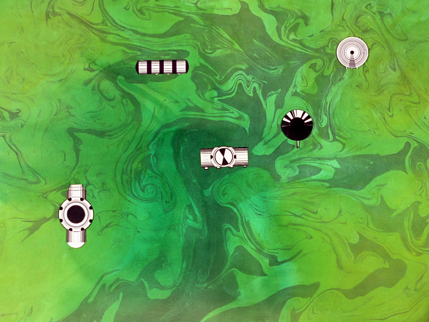top down view of black & white robots in a green space